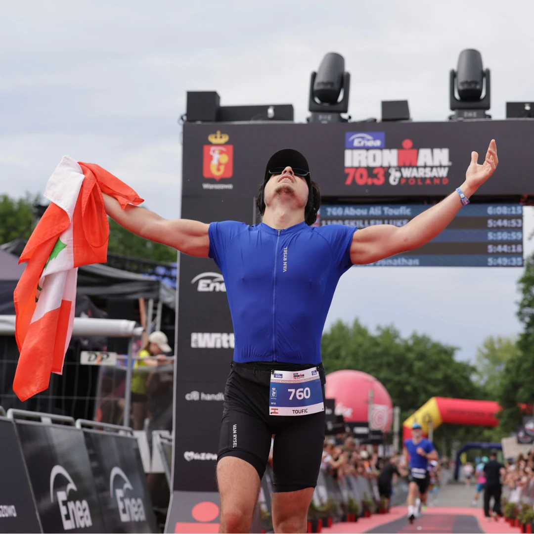 Toufic Abou Ali crossing the IRONMAN 70.3 Warsaw finish with the Lebanese flag